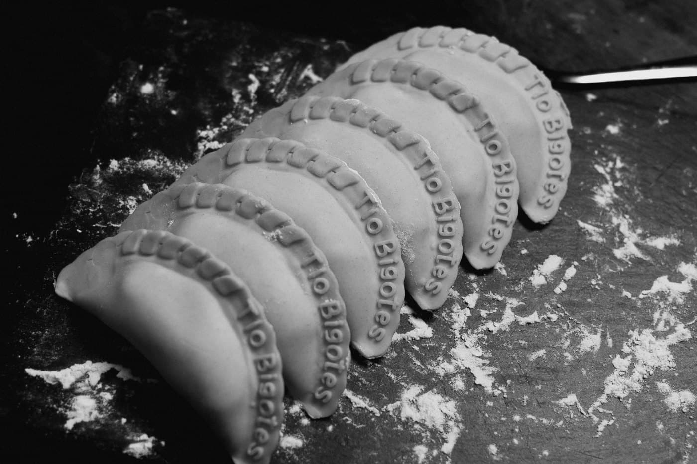 Fila de empanadas con el sello Tío Bigotes